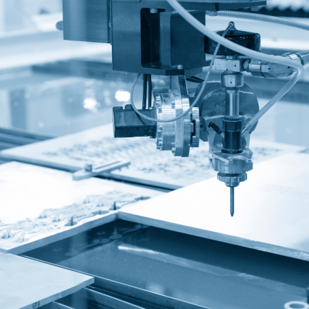 Close-up of a water jet cutting machine precisely cutting metal sheets using high-pressure water. The process ensures clean, accurate cuts without heat distortion, making it ideal for industrial and manufacturing applications. 